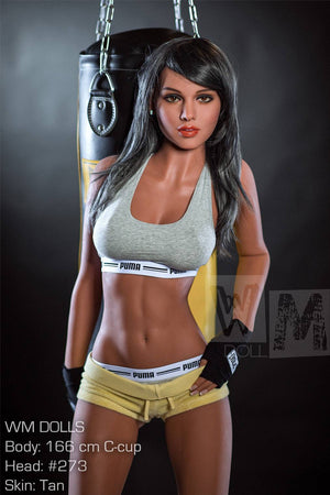 Sex dollfigure of a woman in athletic wear standing next to a punching bag.